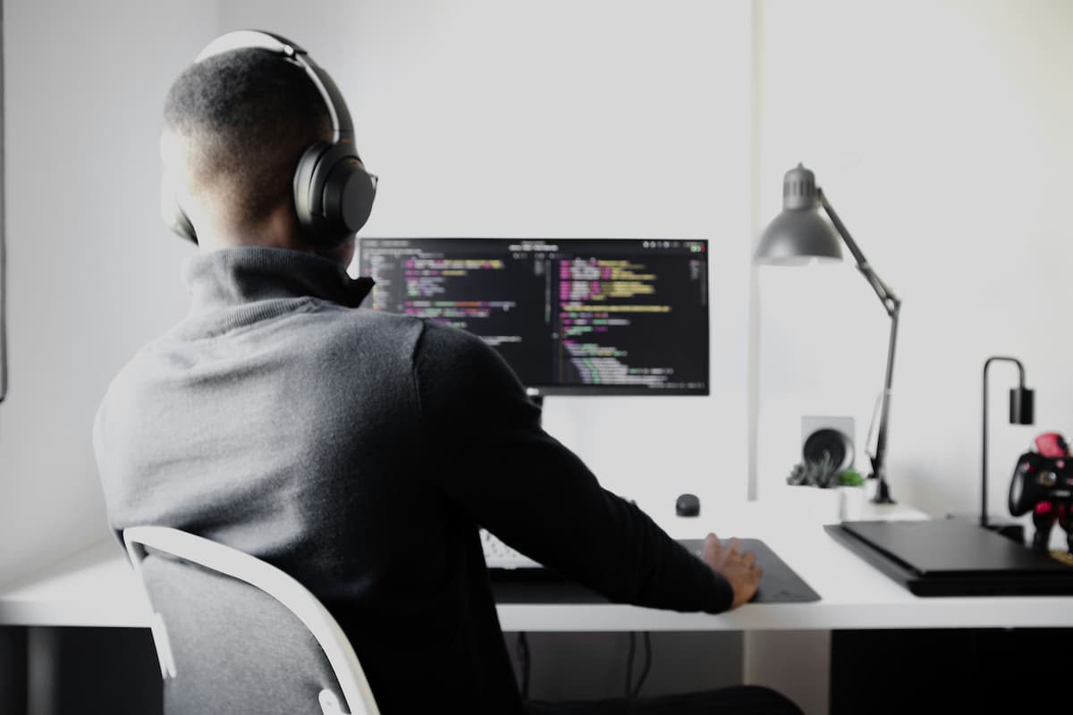 Developer coding at a desk, illustrating the role of technology and digital transformation in law firms.